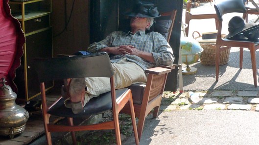 Sleeping at the flea market, Sunday afternoon. Photo by Julie Seyler